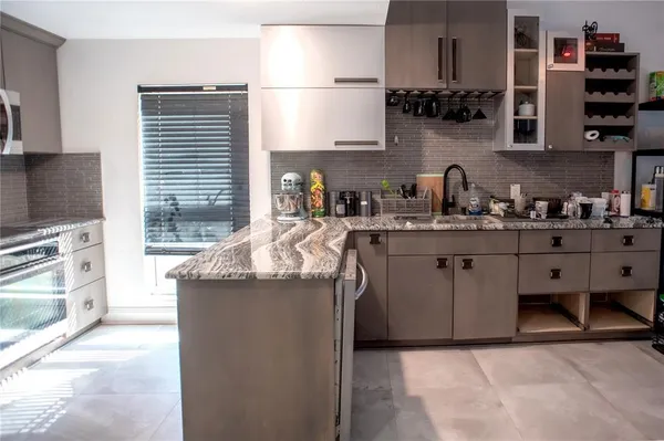 a kitchen with stainless steel appliances granite countertop a sink stove and cabinets