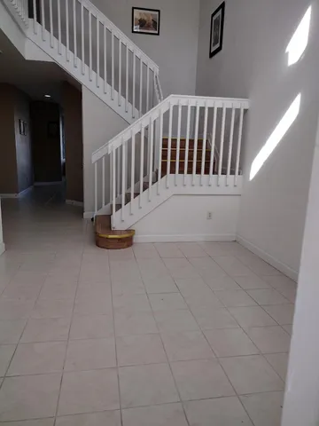 a view of staircase with white walls