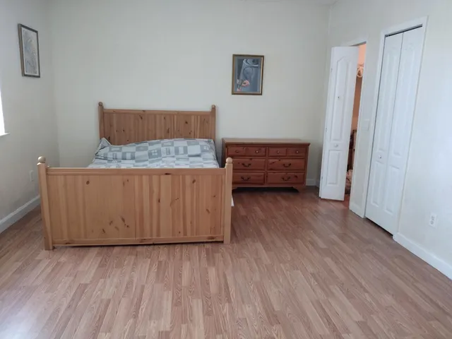 a room with wooden floor and furniture