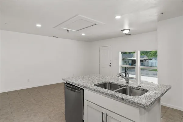 a kitchen with granite countertop a sink and cabinets with granite countertops