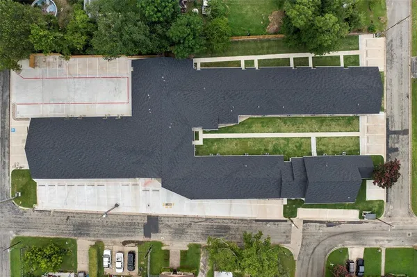 an aerial view of a house with a yard