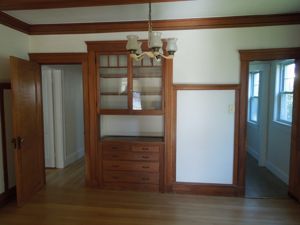 11 Clyde Road, Unit 11 Watertown, MA 02472 - Photo 3 of 7 an empty room with wooden floor closet and windows