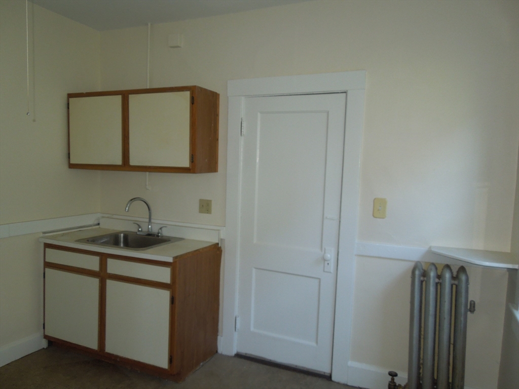 11 Clyde Road, Unit 11 Watertown, MA 02472 - Photo 7 of 7 a bathroom with a granite countertop sink and a mirror