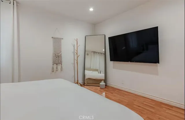 a bedroom with a bed and a flat screen tv