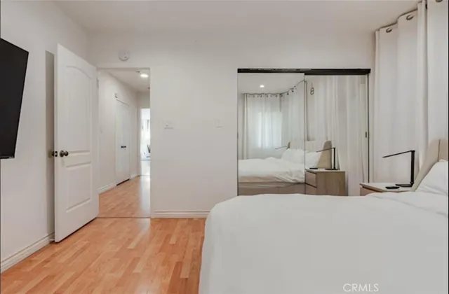 a bedroom with a bed and a mirror