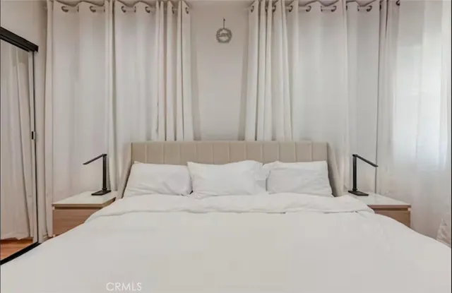 a bedroom with a bed and a mirror
