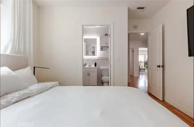 a bedroom with a bed and glass door