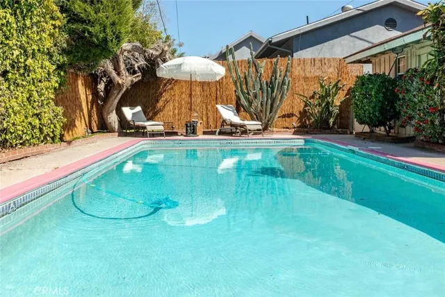 a view of a swimming pool with an outdoor seating and a yard