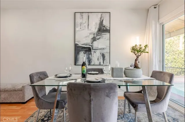 a dining room with furniture and wooden floor