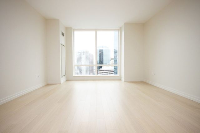 an empty room with large windows