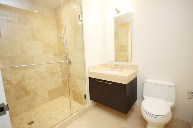 a bathroom with a shower and a sink