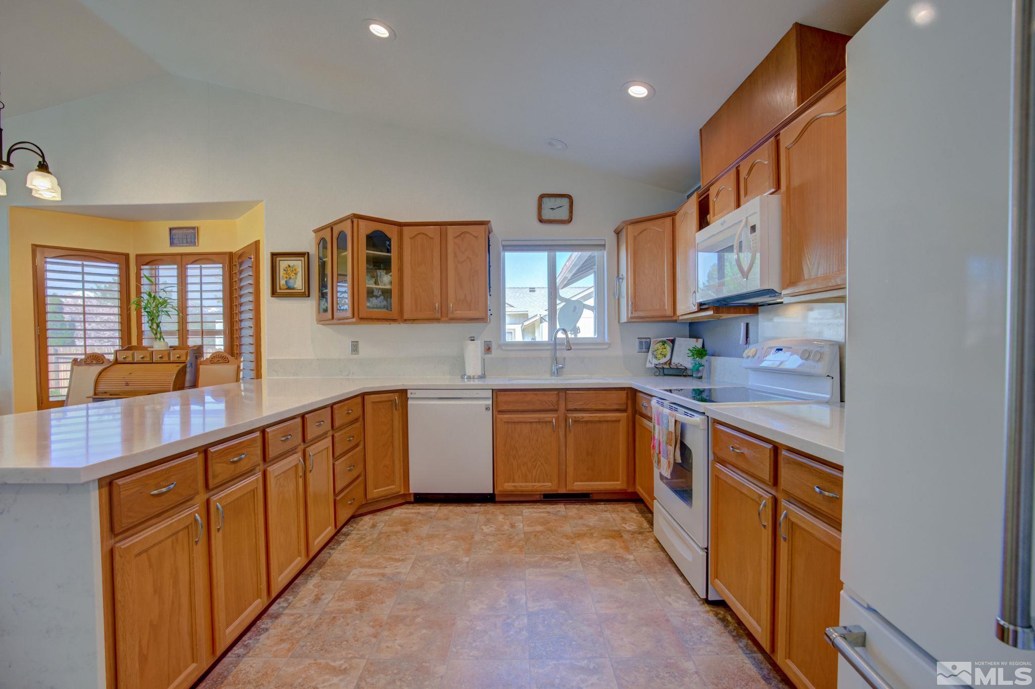 1315 Wrangler Circle Minden, NV 89423 - Photo 12 of 40 a kitchen with stainless steel appliances granite countertop a sink and cabinets