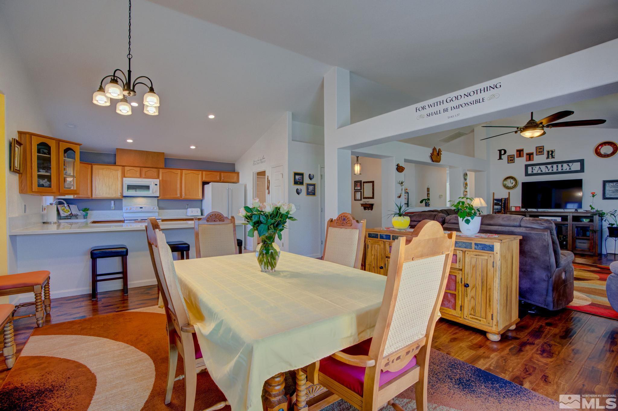 1315 Wrangler Circle Minden, NV 89423 - Photo 15 of 40 a view of a dining room with furniture and wooden floor