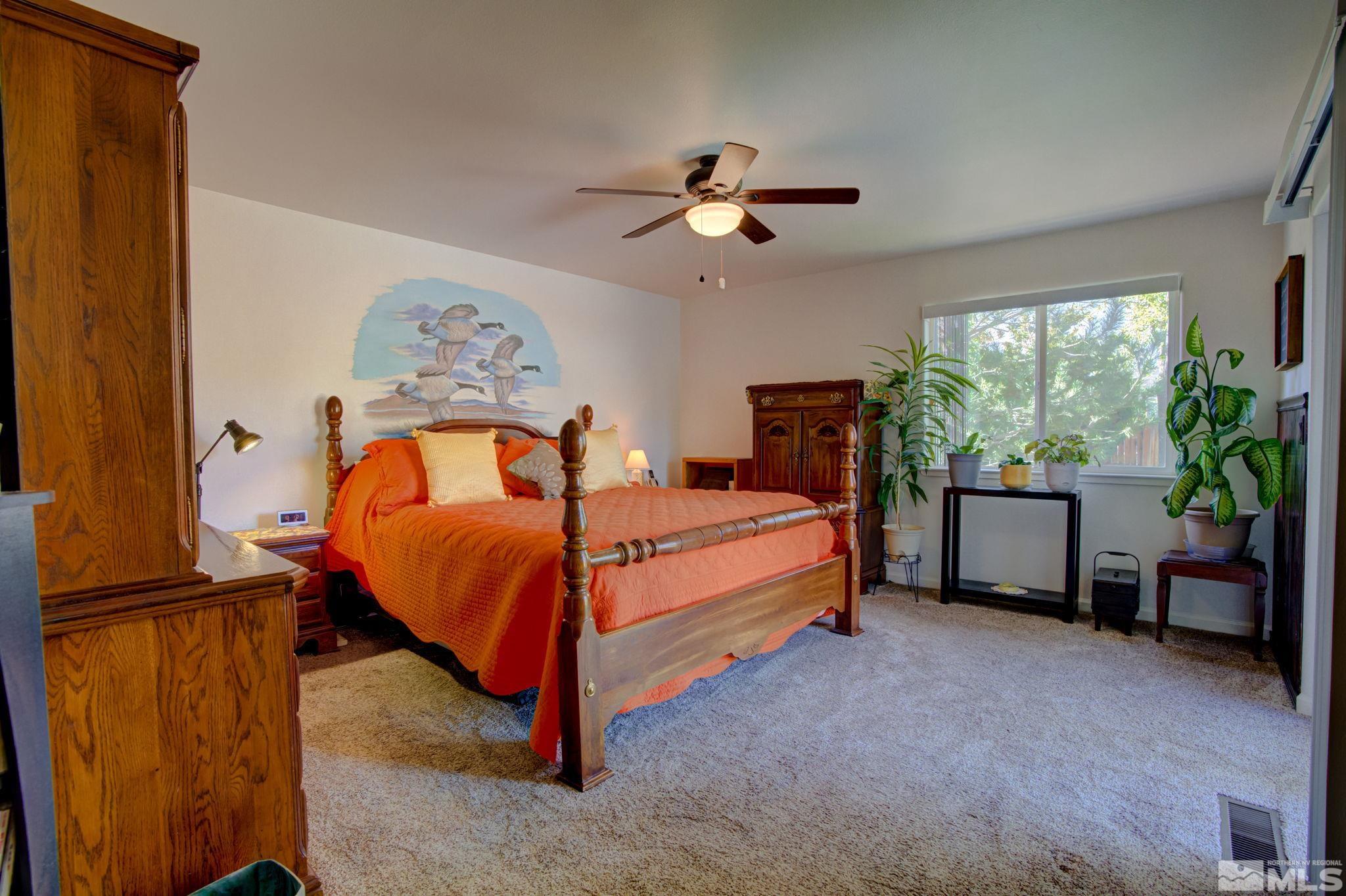 1315 Wrangler Circle Minden, NV 89423 - Photo 16 of 40 a bedroom with a bed and a potted plant