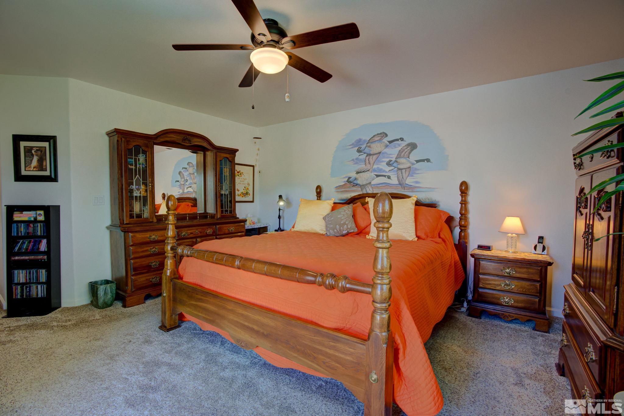 1315 Wrangler Circle Minden, NV 89423 - Photo 17 of 40 a bedroom with a bed and a chandelier