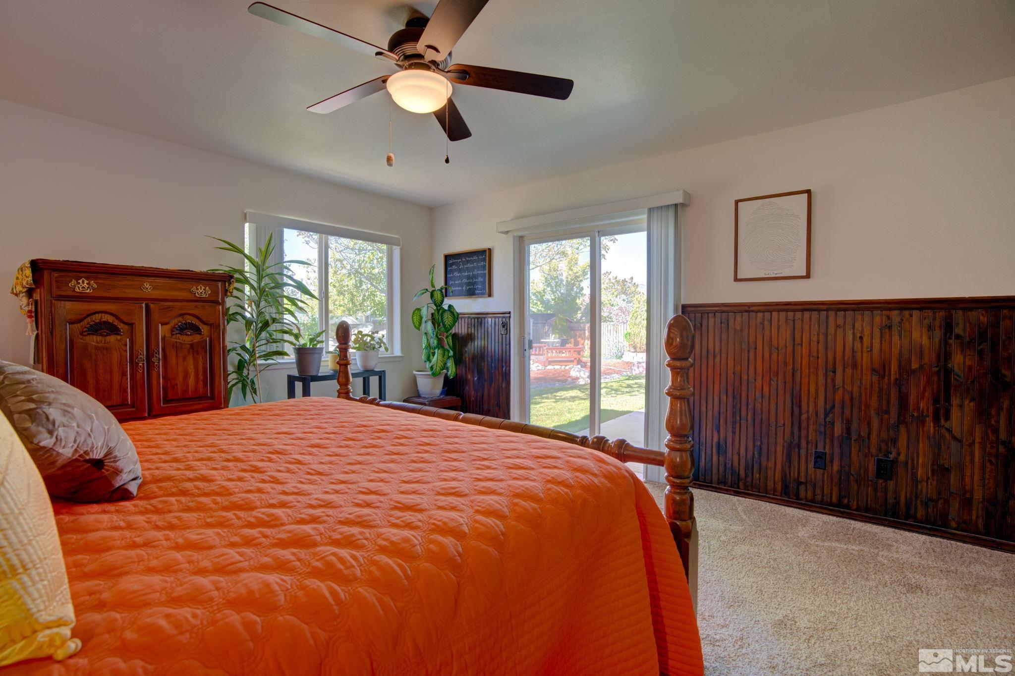 1315 Wrangler Circle Minden, NV 89423 - Photo 19 of 40 a bedroom with a bed and a large window with a chandelier