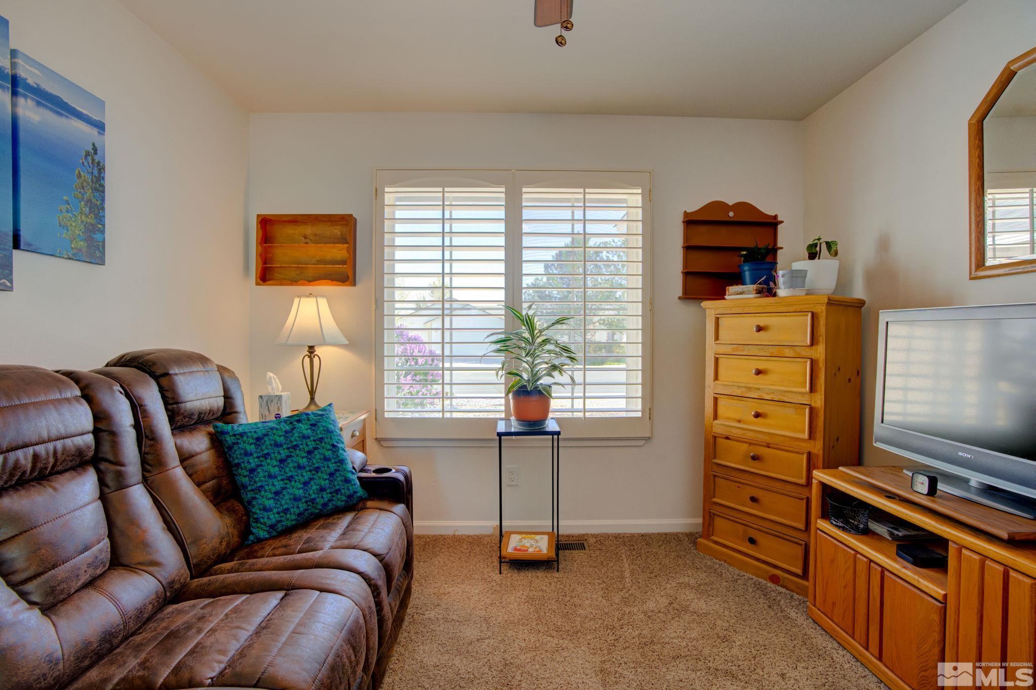 1315 Wrangler Circle Minden, NV 89423 - Photo 23 of 40 a bedroom with furniture and a flat tv screen