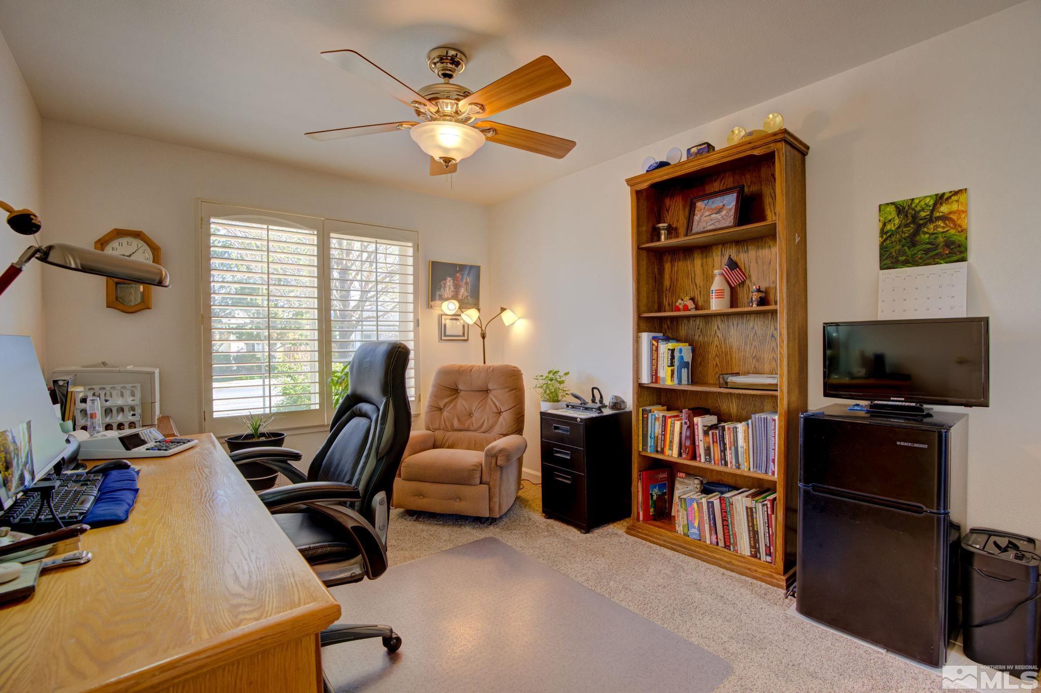 1315 Wrangler Circle Minden, NV 89423 - Photo 25 of 40 a living room with furniture cabinets and a flat screen tv