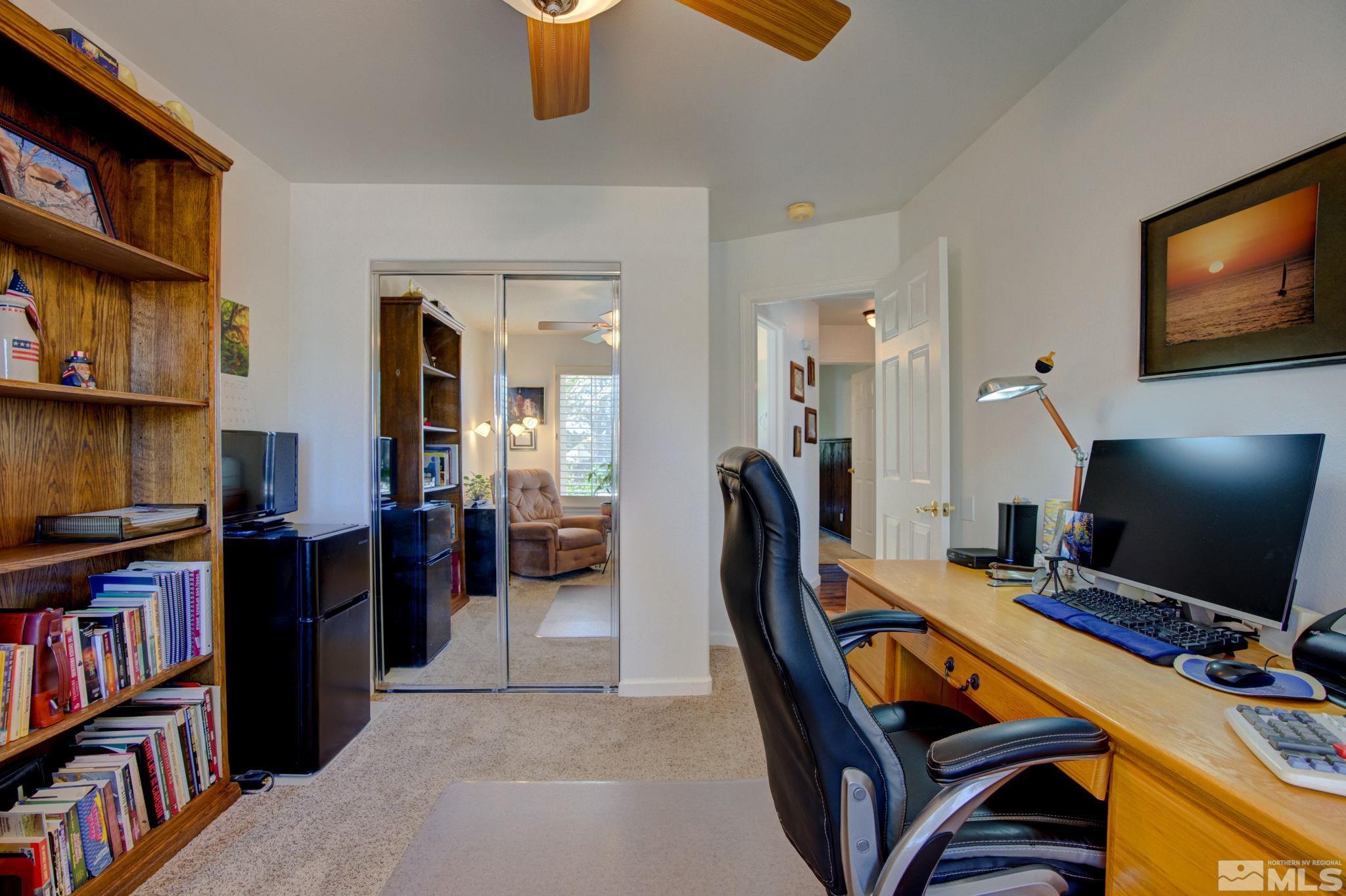1315 Wrangler Circle Minden, NV 89423 - Photo 27 of 40 a view of a workspace with furniture and a bookshelf