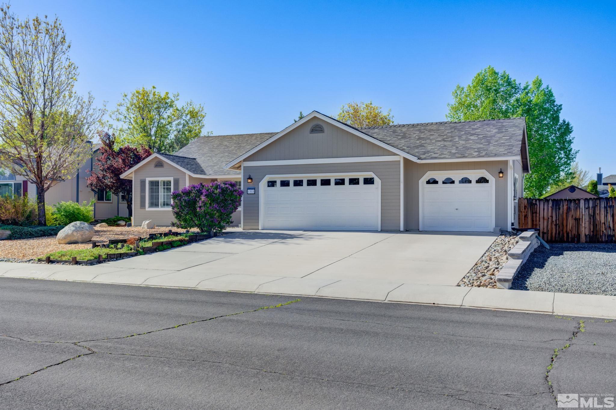 1315 Wrangler Circle Minden, NV 89423 - Photo 3 of 40 a front view of a house with a yard and garage