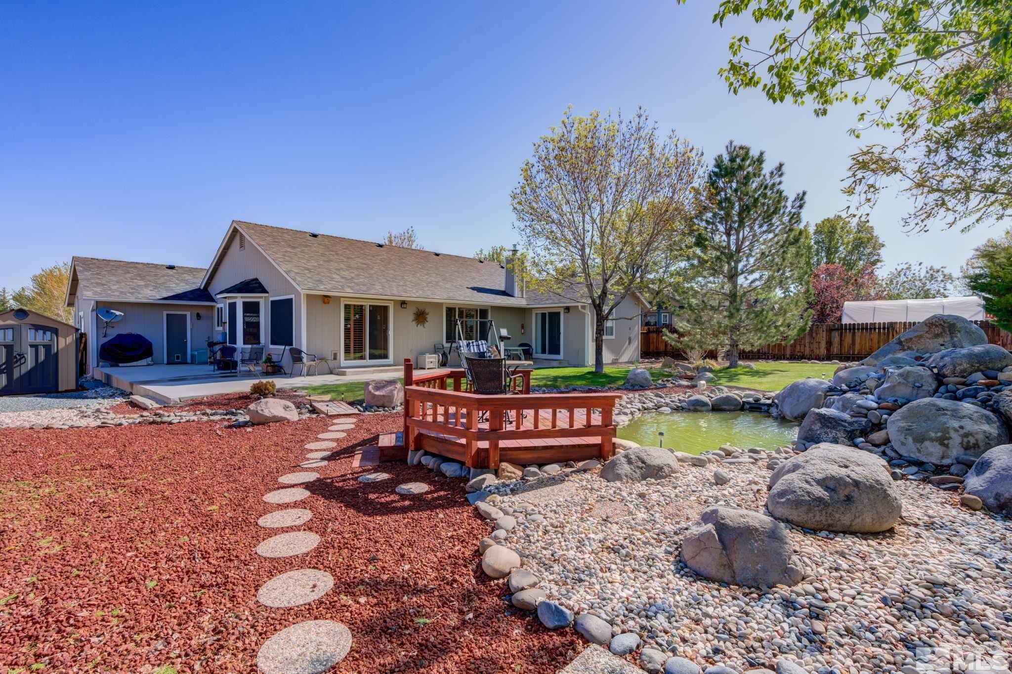 1315 Wrangler Circle Minden, NV 89423 - Photo 32 of 40 a front view of a house with swimming pool table and chairs
