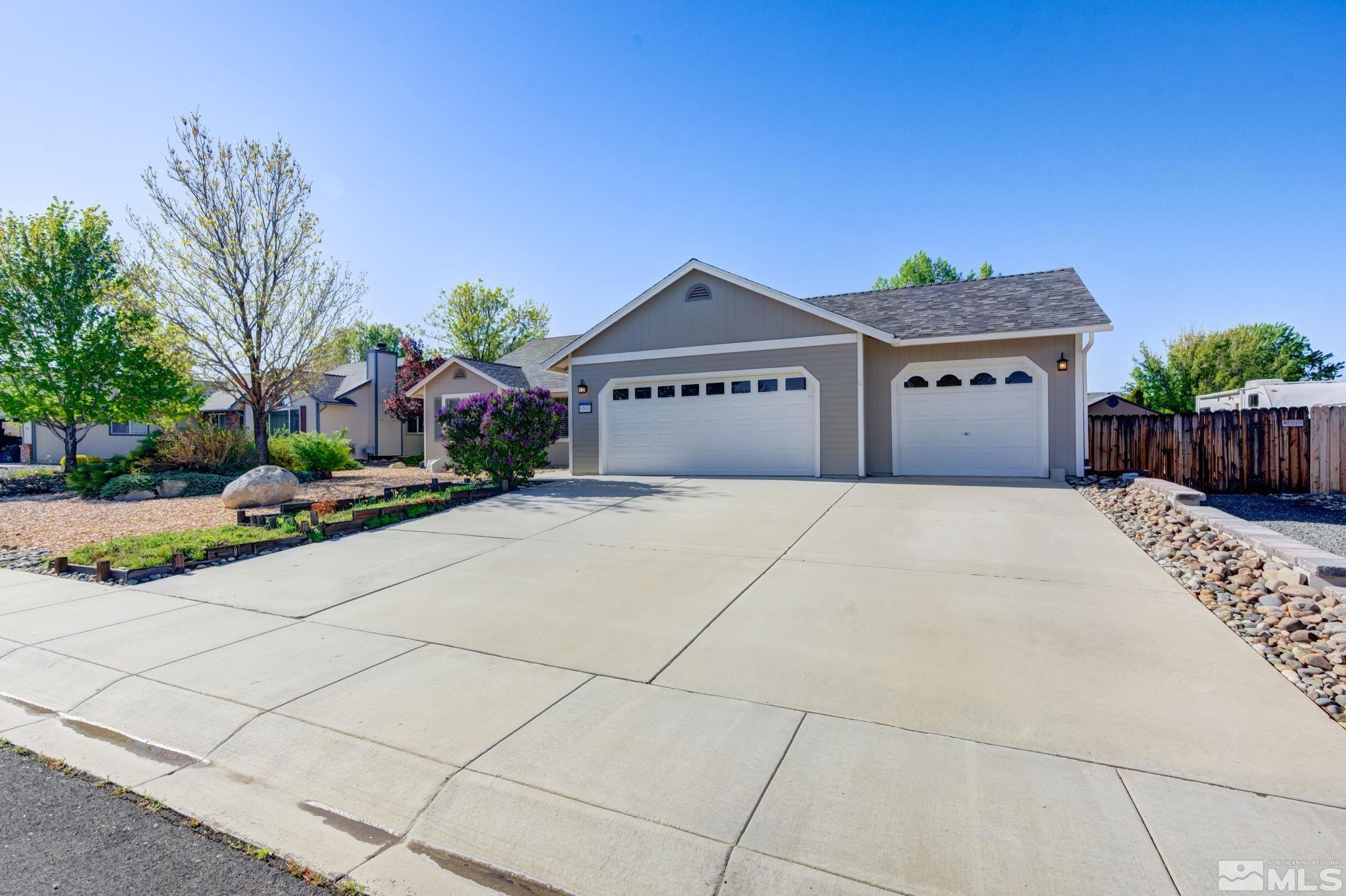 1315 Wrangler Circle Minden, NV 89423 - Photo 4 of 40 a front view of a house with a yard and potted plants