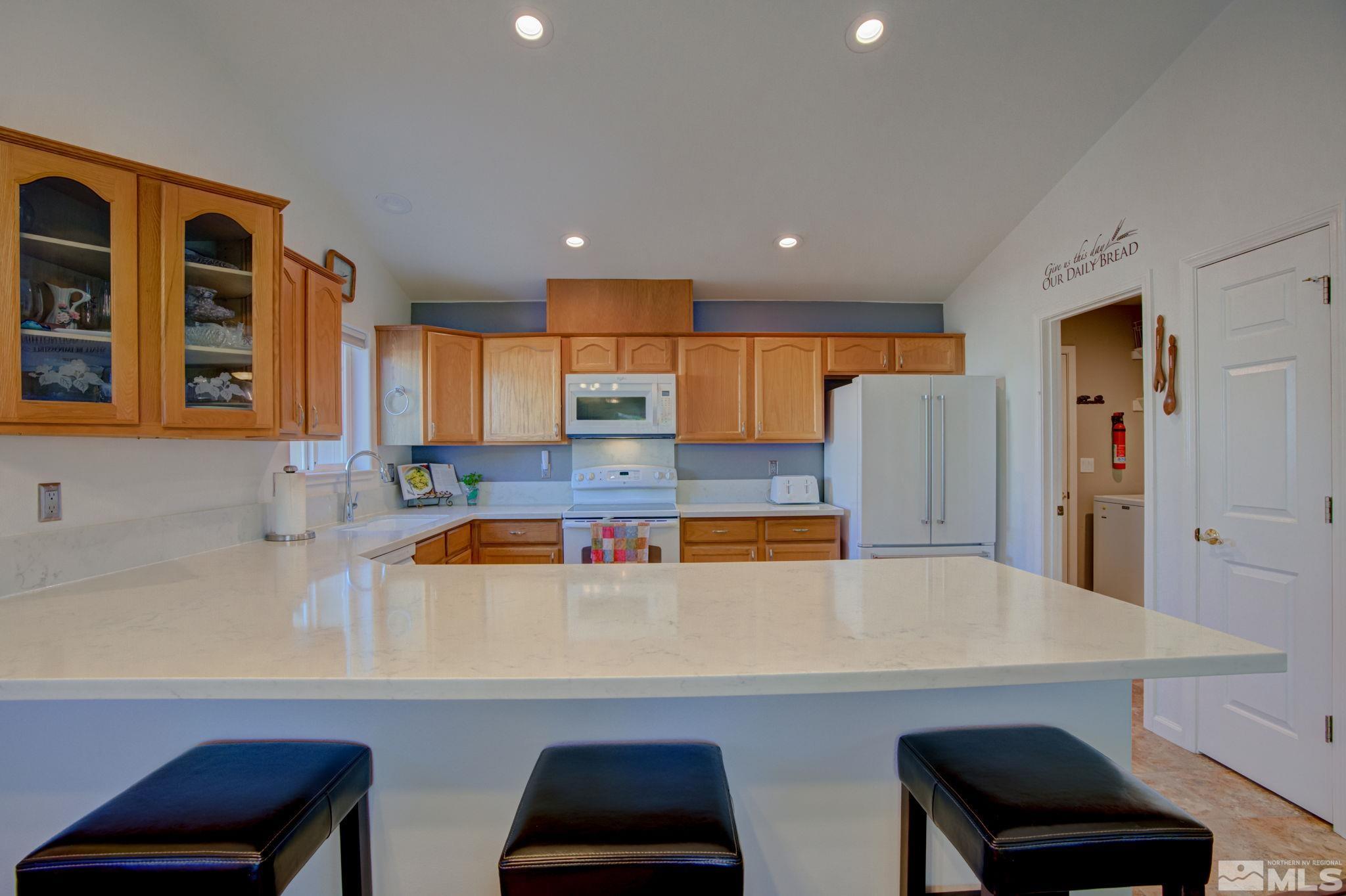 1315 Wrangler Circle Minden, NV 89423 - Photo 10 of 40 a kitchen with stainless steel appliances a refrigerator and a sink