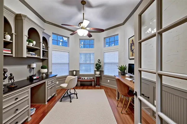 a very nice looking room with many windows and furniture