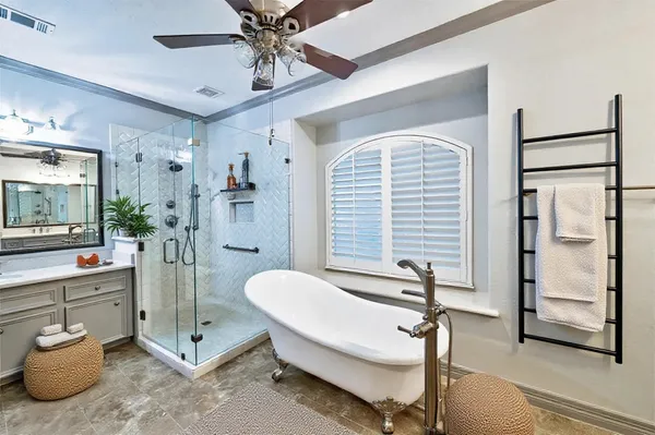 a spacious bedroom with a bed and a chandelier