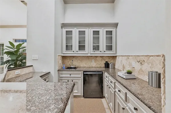 a kitchen with stainless steel appliances granite countertop a sink stove and cabinets