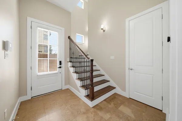 a view of a hallway with windows and stairs