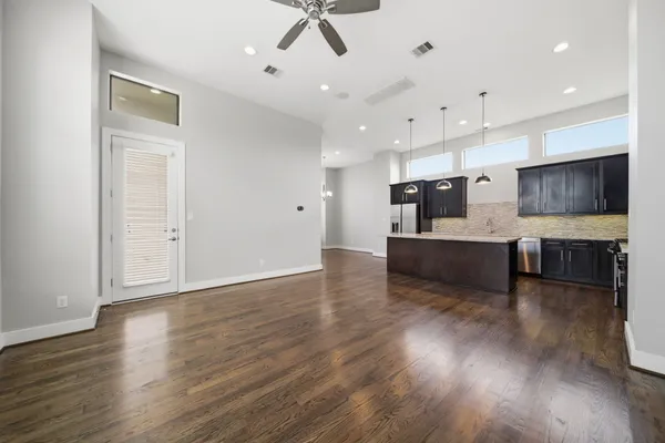 a view of kitchen with wooden floor and electronic appliances