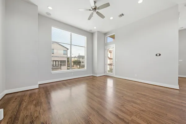 wooden floor in an empty room with a window
