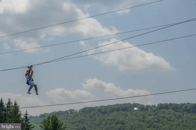 a view of a golf ground with a table and chairs