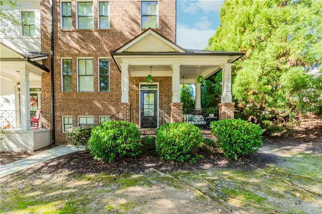 a view of a brick house with potted plants