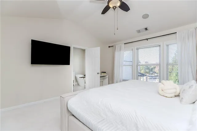 a spacious bathroom with a double vanity sink mirror and bathtub