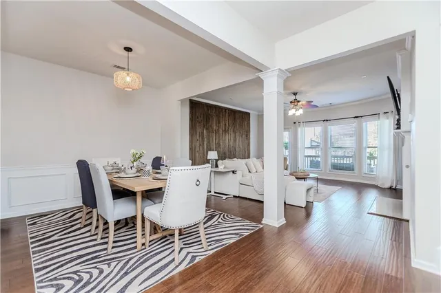 a view of a dining room with furniture and wooden floor