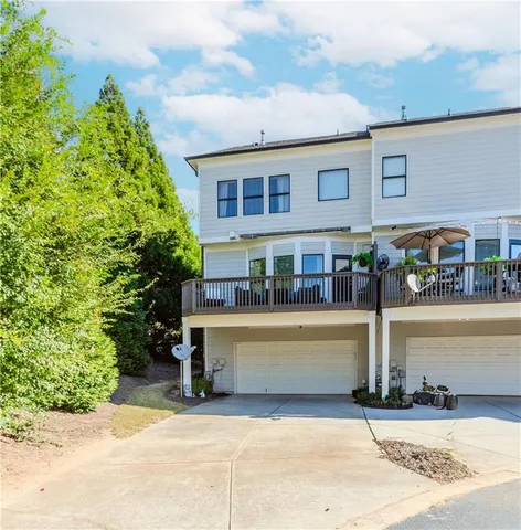 a view of house with swimming pool and outdoor seating