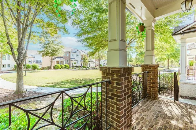 a view of a balcony with wooden floor and outdoor seating