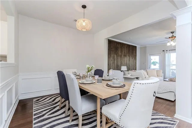 a dining room with furniture a rug and wooden floor