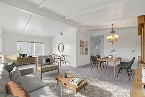 a living room with furniture a dining table and a chandelier