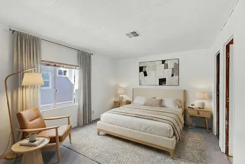 a bedroom with a bed and chair