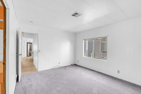 an empty room with windows and closet