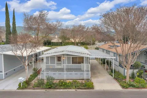 a front view of a house with a yard and table and chairs