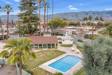 an aerial view of a house with a swimming pool