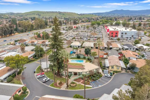 an aerial view of a house with a yard and lake view