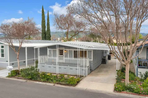 a front view of a house with a garden