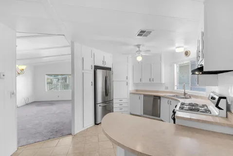 a large kitchen with cabinets and stainless steel appliances