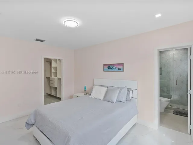 a bedroom with a bed and a lamp