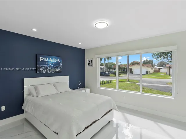 a bedroom with a large bed and a large window